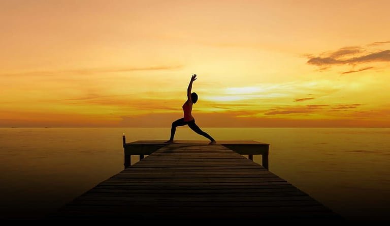 Yoga students moving through a Vinyasa flow sequence
