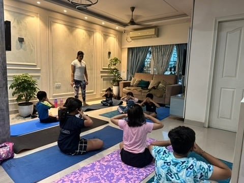 Kids doing Bhramari breathing exercise in class
