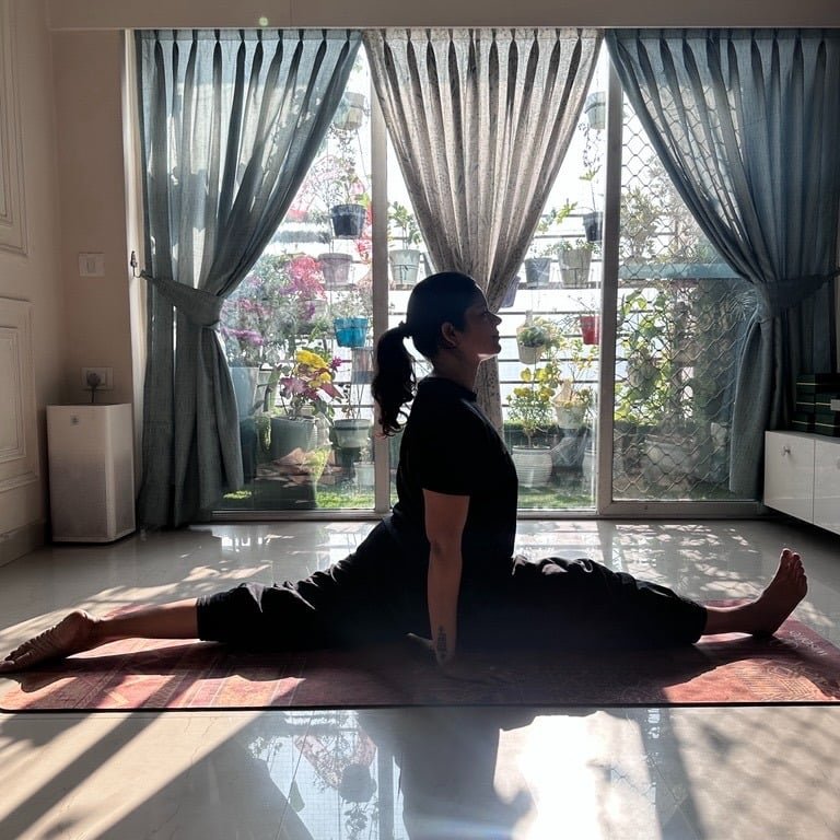 Founder Ritu Dubey performing Hanumanasana (Split Pose) in yoga studio