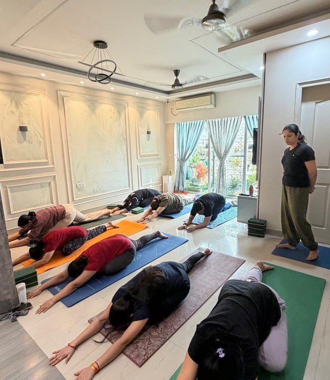 Student in forward-fold One-Legged King Pigeon Pose during class